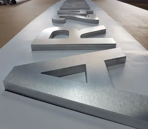 Logo en aluminio cepillado sobre base pvc